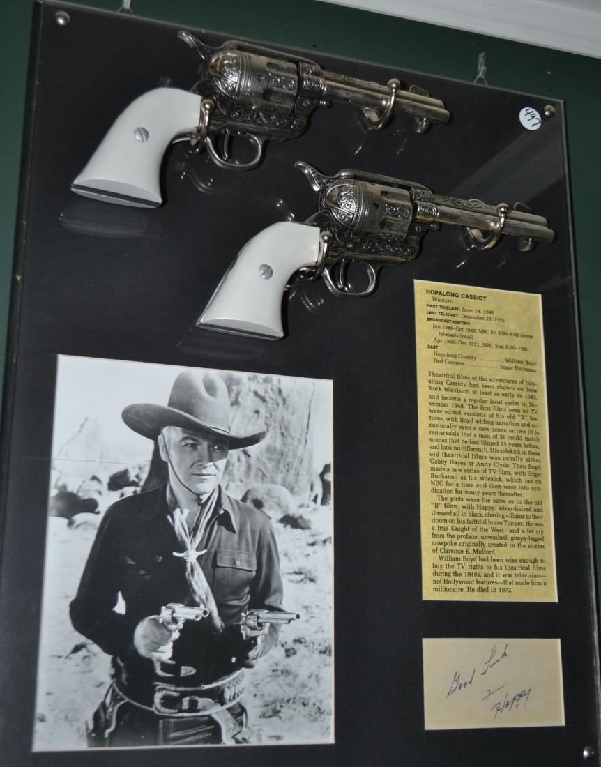 Hopalong Cassidy display w/2 Denix revolvers: Hopalong Cassidy custom display with two (2) mounted high quality cast metal "Denix" replica revolvers, autograph, picture and information card. Approx. 17" x 20"