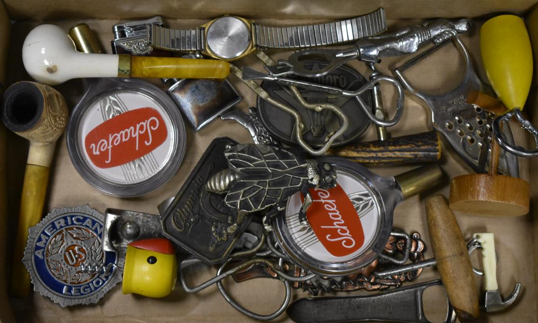 Beer and Tobacco Related Items: Including two vintage tobacco pipes, a corkscrew with a bone handle, an insect bottle opener, a Knight bottle opener, two Schaefer beer taps, two vintage lighters and two related belt buckles.