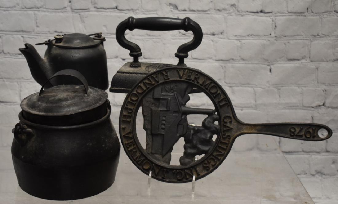 Vintage Cast Iron Cookware Grouping: Including a Wagner Ware Sidney #0 teapot, a one quart cast iron pot with lid, a sad iron and a trivet from Randolph, Vermont dated 1978.