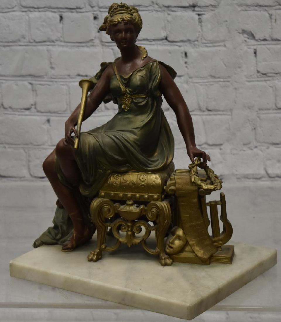 Female Figure on Marble Base: Item measures approx. 13"h. It depicts a seated woman with a horn and laurel wreath. She seats upon a marble base and is marked "Ansonia Clock Co" on base.