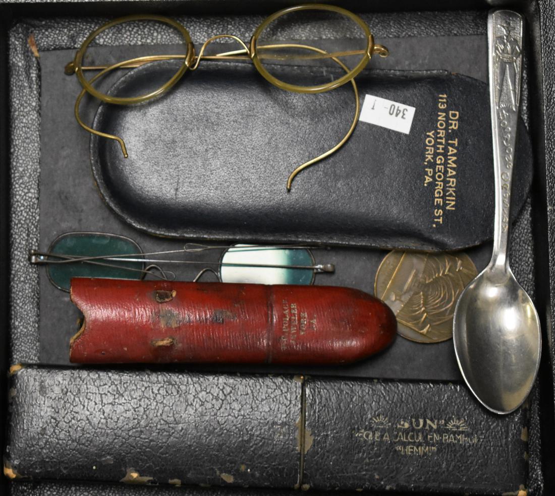 Vintage Eye Glasses and other Interesting Items: Including a pair of civil war era sun glasses with aqua lens with the original case marked York. Pa., a pair of vintage eyeglasses gold filled frames, Sun Hemmi slide rule and a token of Westminster H