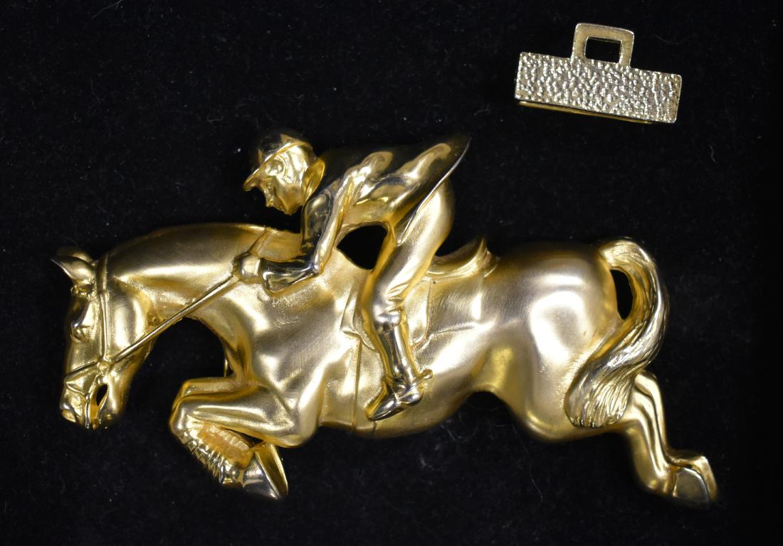 Large Equestrian Belt Buckle: Item measures approx. 6" in length. It depicts a jumping horse with a rider and is marked "DR 94" on the back.
