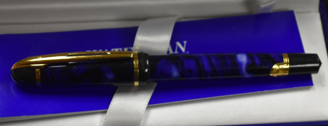 Blue Marbleized Waterman Pen: Pen has a blue marbleized body with gold tone hardware. It comes in the original box with paperwork and appears to be unused.