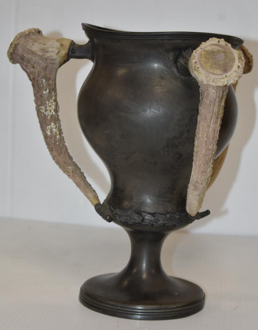 Early 20thC Loving Cup with Stag Handles: Item measures approx. 11 1/2"h. It has a fluted top and three stag/antler handles. Handles are missing base pins but are still attached. Item has a pewter body but may have been silver plated at one t