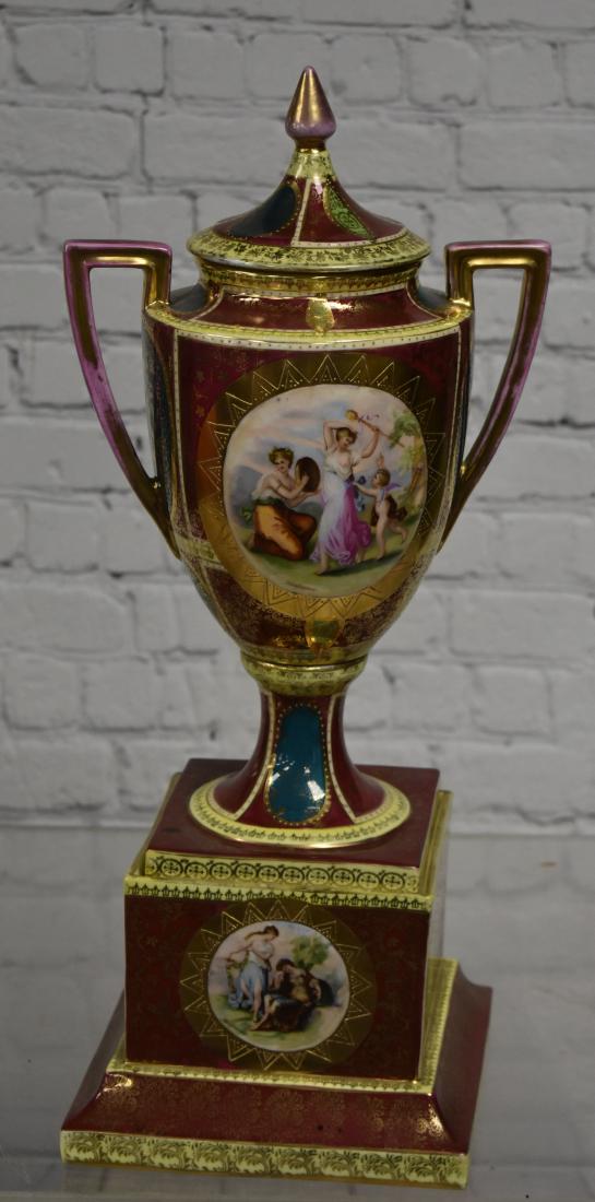 Massive Royal Vienna Urn: Item measures approx. 19 1/2"h to top of finial. It is a multi colored urn with heavy gold flashing. There is some common wear to flashing. Item is free of chips and cracks and has the Royal Vienna be