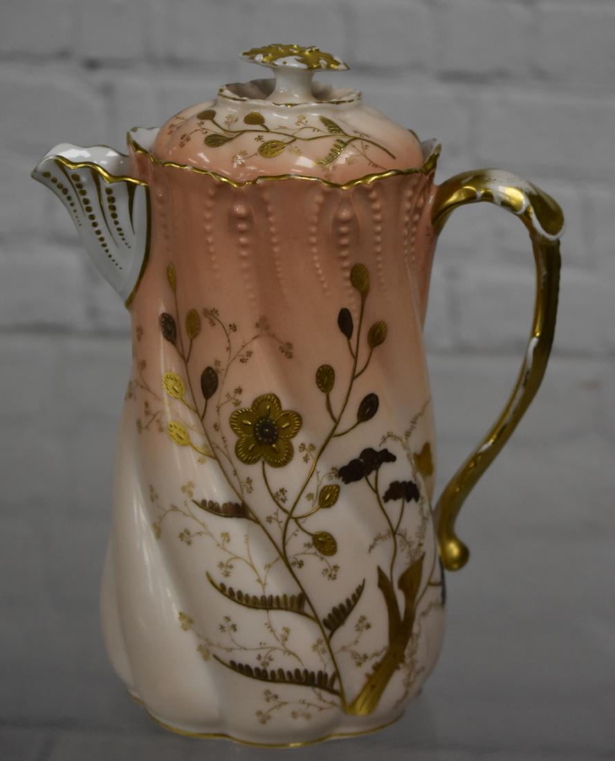 Elite Limoges Chocolate Pot: Item measures approx. 8 1/2" h to top of finial. It has a salmon body with hand painted gold flowers. There is common wear to gold flashing on handle and top of lid. Item is free of chips and cracks a