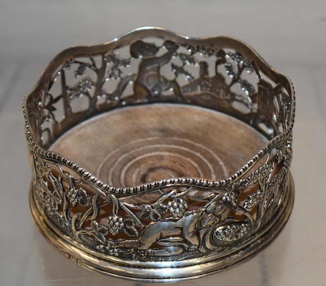 19thC Sterling English Wine Caddy: Item measures approx. 3"h x 5 1/4"dia. It has an ornate design with grapevines, putti figures, a wind mill and a crest with an eagle wearing a crown. The passant is a leopard head, a crown and a lion