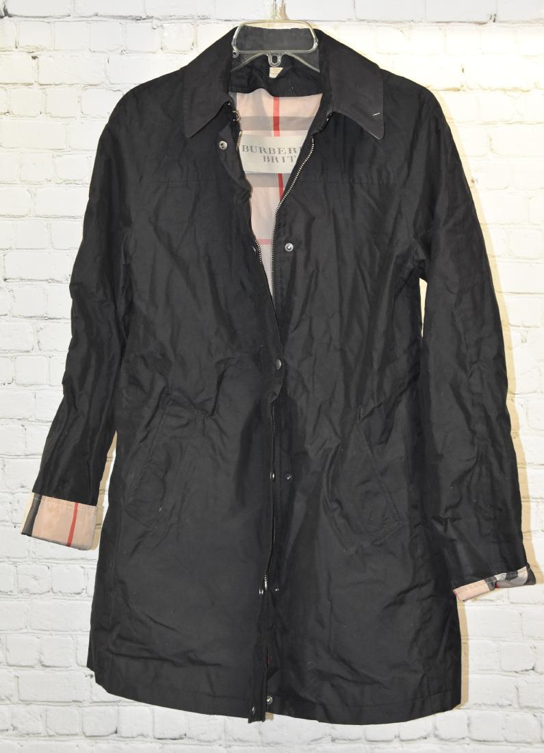 Burberry Brit Raincoat: Item has signature nova check print inside. It is a zip up jacket with a check collar. It is a lady's size 4 and has a small rip on inside lining.