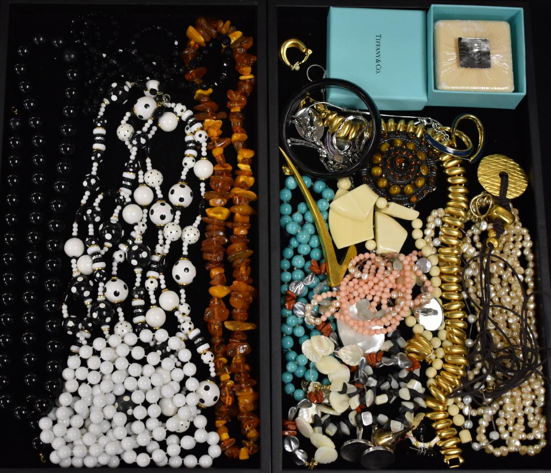Necklaces and other Costume Jewelry: Including a freshwater pearl necklace, a shell and coral necklace, a necklace with amber colored stones, a heavy gold toned necklace marked "Irwin Peale" and other costume jewelry.