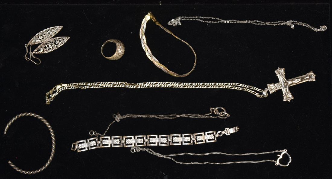 Sterling Jewelry Grouping: Including three sterling bracelets - one marked "Italy", four sterling chains - one with a crucifix, a pair of sterling earrings and a large sterling men's ring. Total weight is 69 grams.