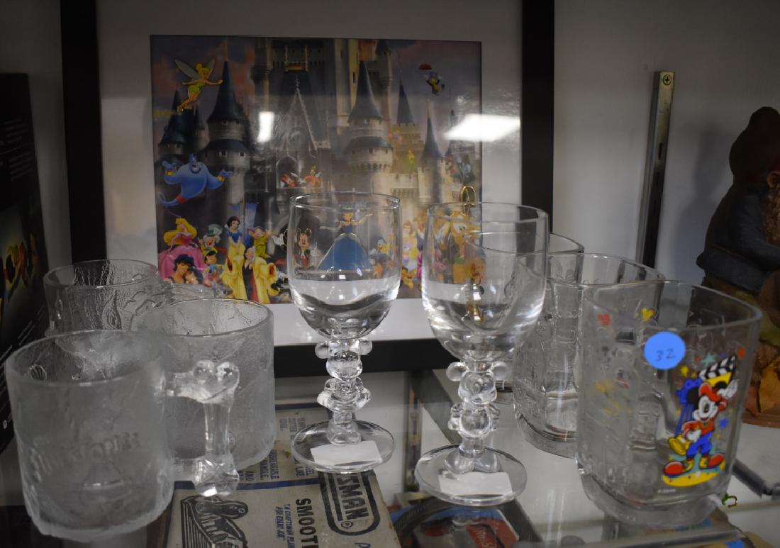 Disney Glassware and Print: Set of Mickey & Minnie Wine Goblets, McDonalds Pre-Dawn Flintstones Series Mugs (3), Walt Disney World Millennium 2000 Glasses McDonalds (3), framed Disney Limited Edition print with Pendants