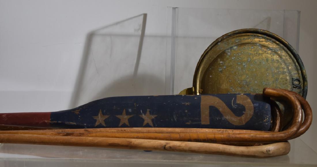 Canes, an Oar and a Bed Warmer: Including four wooden canes - one from "Benny's", a contemporary folk art oar and a brass bed warmer showing some oxidation.