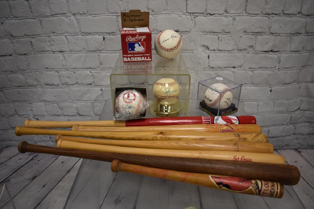 Autographed Baseballs and Mini Bats: Seven St, Louis Cardinals Miniature bats, a baseball autographed by Harmon Killebrew, two baseballs signed by Andre Dawson and a facsimile signed St. Louis Cardinals baseball.. Note: Auction company d