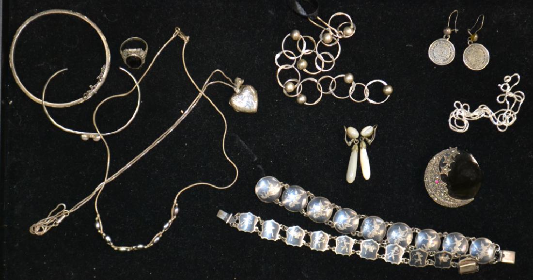 Siam and other Sterling Jewelry: Includes two Siam bracelets, a sterling heart shaped locket on a chain, a sterling ring with an onyx stone, a sterling moon and star pin and other quality sterling jewelry.