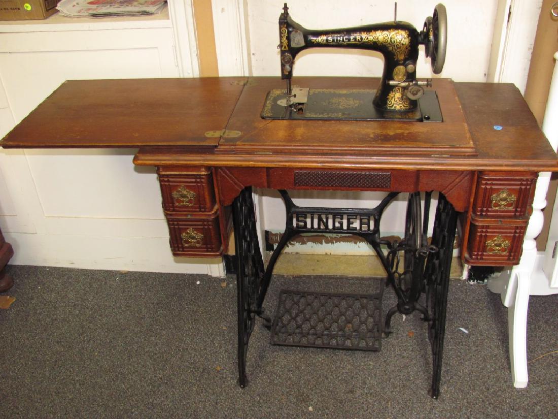 Singer Treadle Sewing Machine: Item measures approx 31"h x 36"w x 18"d. It has an oak case, four drawer with original hardware and is complete except for missing belt.