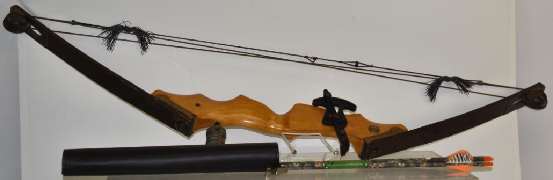 Vintage "Bear" Compound Bow: Item is constructed of laminate maple. It has a working pulley system and original brass Bear tag. Note: Item comes with the quiver and four practice arrows.