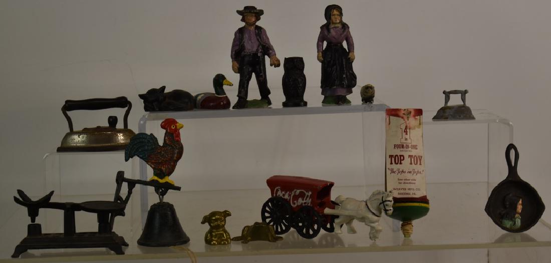 Cast Iron Toys and Miniatures: Including cast iron Amish miniatures, various cast iron animals, a miniature iron, a four in one top and other items.