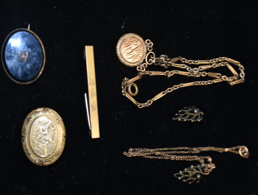 Victorian Jewelry Grouping: Including a necklace and small pin set with onyx and seed pearls, a monogram pendant on chain, two oval shaped pins (one has a cracked onyx in center) and a monogrammed bar pin.