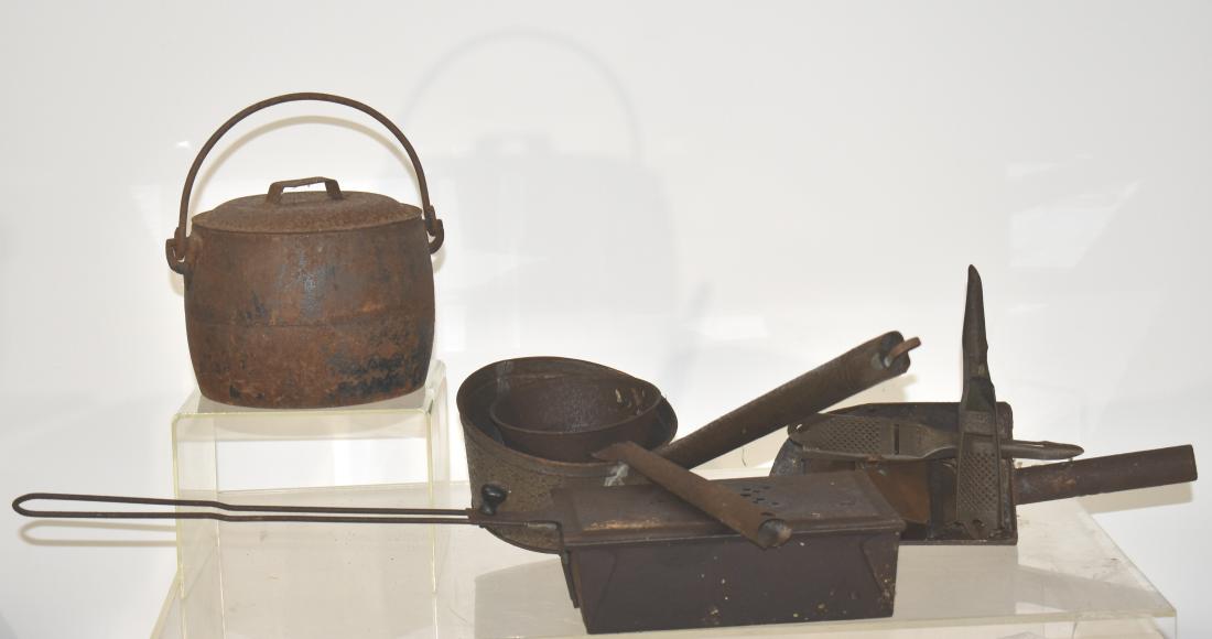 Vintage Kitchen Country Ware: Including two hand soldered tin dippers, a scoop with a cast handle, a tin match safe, a cast kettle with a tin lid and two graters. All items show oxidation.
