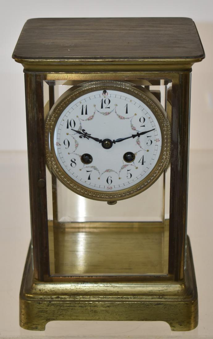"Samuel Marti" Tiffany & Co Mantle Clock: Item measures approx. 10 1/2"h x 6 1/2"w x 5 1/2'd. It has a solid brass body with beveled glass panels, a porcelain face, a Samuel Marti stamp and The Tiffany & Co stamp on the back and is also marke