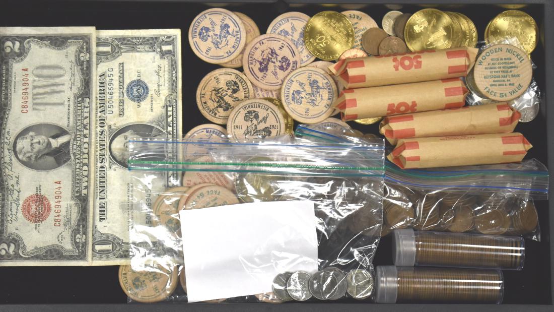 Vintage Coins, Currency and Tokens: Including approx. four hundred wheat pennies, eleven steel pennies, a 1935E one dollar silver certificate, a 1928D two dollar silver certificate and a large selection of brass and wooden tokens.