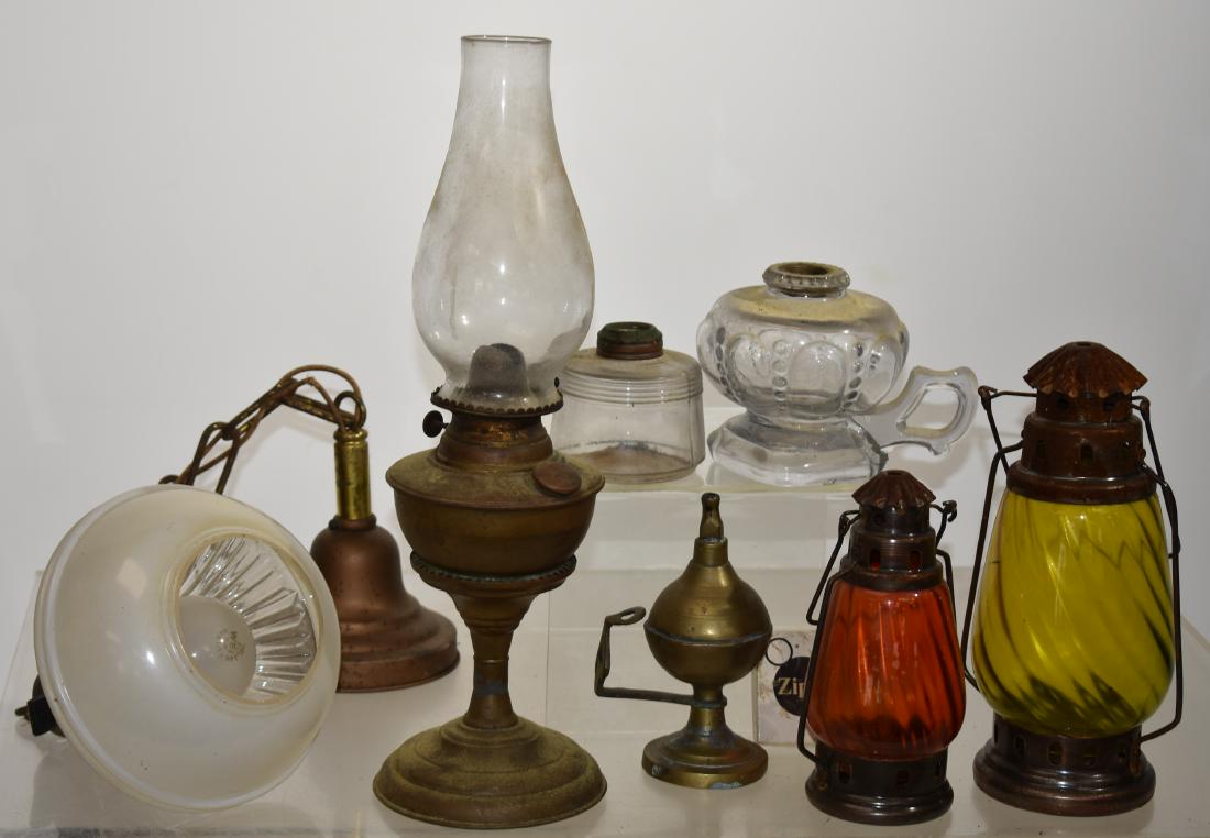 Oil Lamps and a Hanging Lamp: Including a brass oil lamp measuring approx. 15"h to top of globe, a finger lamp, a 1920's hanging lamp, two contemporary candle lamps made in India and other related items.