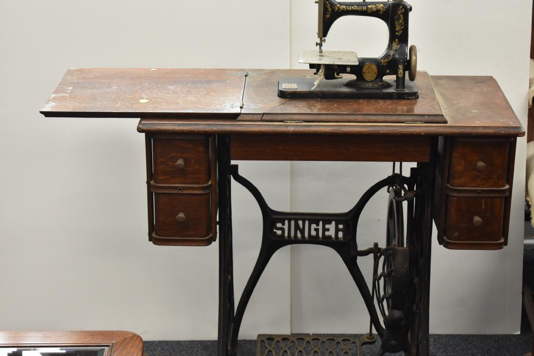 Oak Treadle Sewing Machine: Item is a Singer sewing machine. It has an oak case, four drawers and is functional.