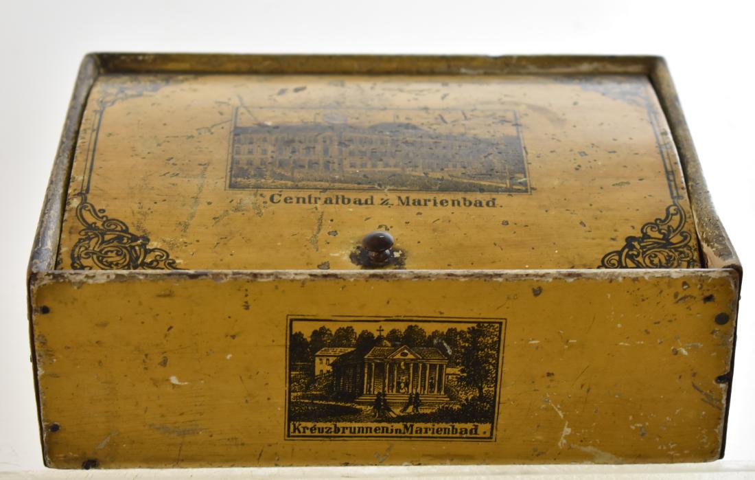 19th Century German Advertising Box: Item measures approx. 7 1/2" across. It is a wooden box with five sided graphics. It has a functional hinge and is all original.