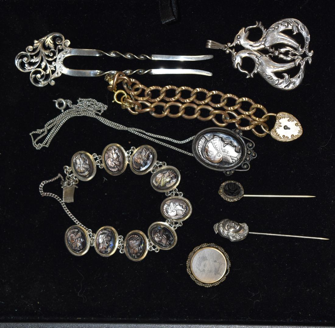 Victorian Jewelry Grouping: Including a gold fill heart locket bracelet, sterling double gargoyle pendant, a sterling hair comb, a 800 silver abalone bracelet and pendant and two stick pins.