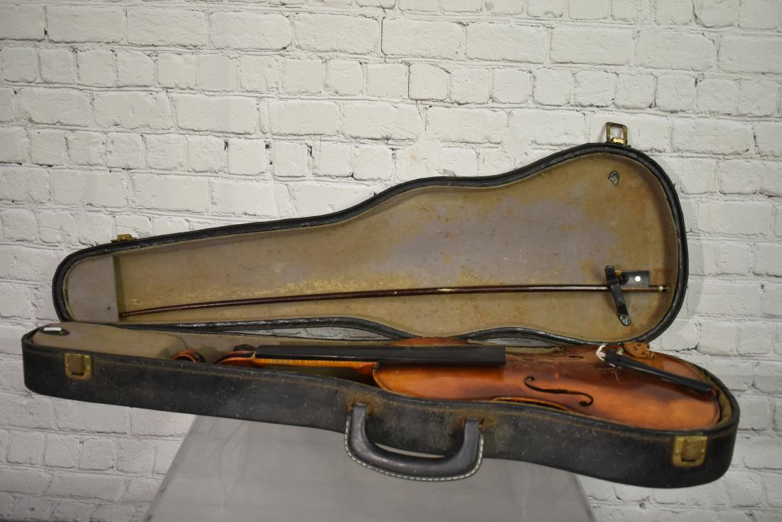 Anton Schroetter German Copy Violin: item has a spruce top, a two piece maple back and maple sides, the neck is tight to the body, the body is tight and the finger board is in good condition. The bow is marked "Germany".