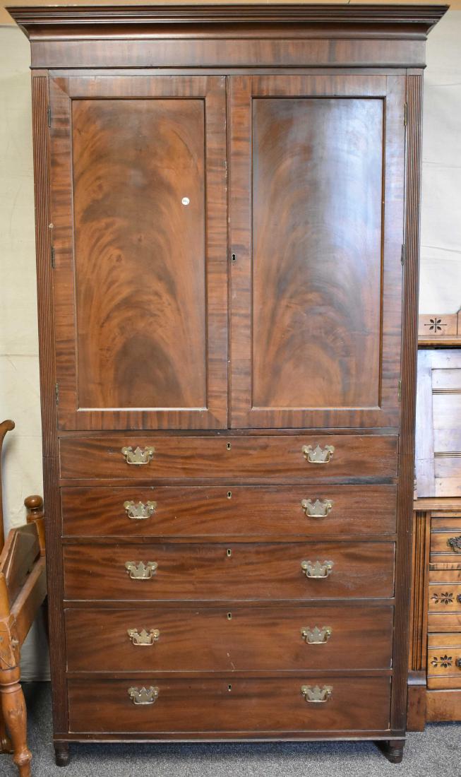 19th Century English Mahogany Linen Press: It is a two piece press. The top has two doors and pull out drawers. The base has five drawers - all are hand dove tailed with locks. Key is included. Item has a good surface. Item measures approx. 86