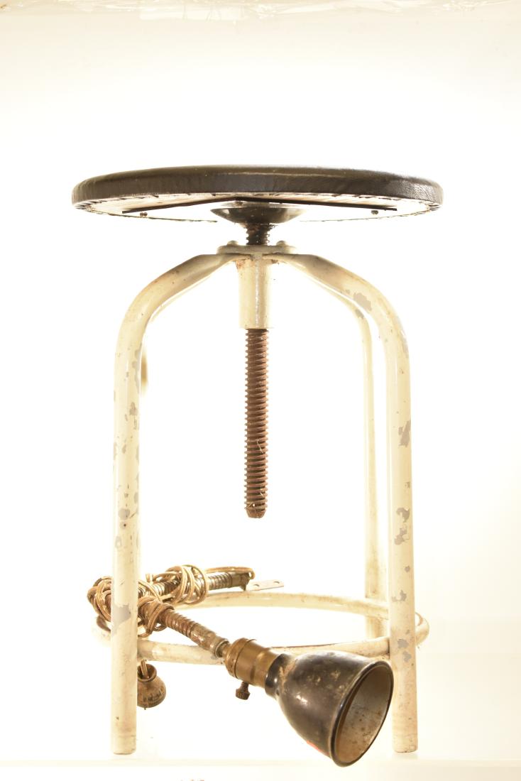 Adjustable Industrial Stool and more: Item has a vinyl over wood top in good condition, an adjustable screw type seat and a tube metal frame. Lot also includes a flexible industrial light with a cracked shade which needs to be rewired.