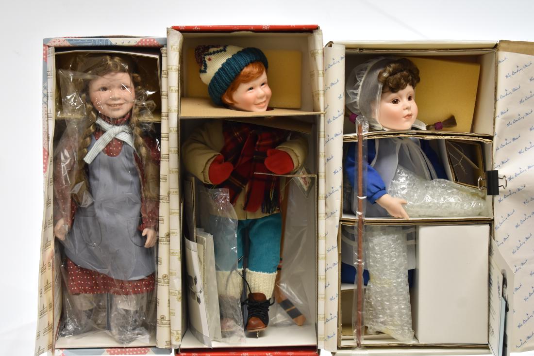 Three Collectible Dolls with Showcases: Including an Ashton Drake "Laura" from Little House on the Prairie", an Ashton Drake "Brian" and a Fayzah "Eliza" doll. Note: showcases are unassembled.