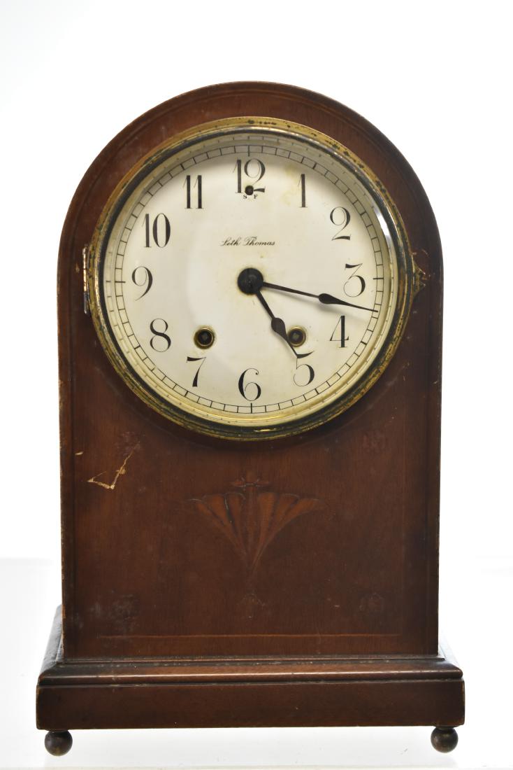Seth Thomas Mantle Clock: Item measures approx. 14 1/2"h. It has an enameled face with floral and beaded inlay on body. It has the original pendulum but no key.