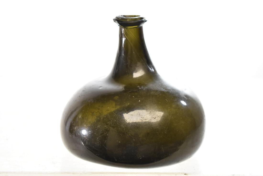 Early Onion Bottle: Bottle measures approx. 6"h. It has chips around sprout. It is a hand blown bottle and is in a very desirable squat form.
