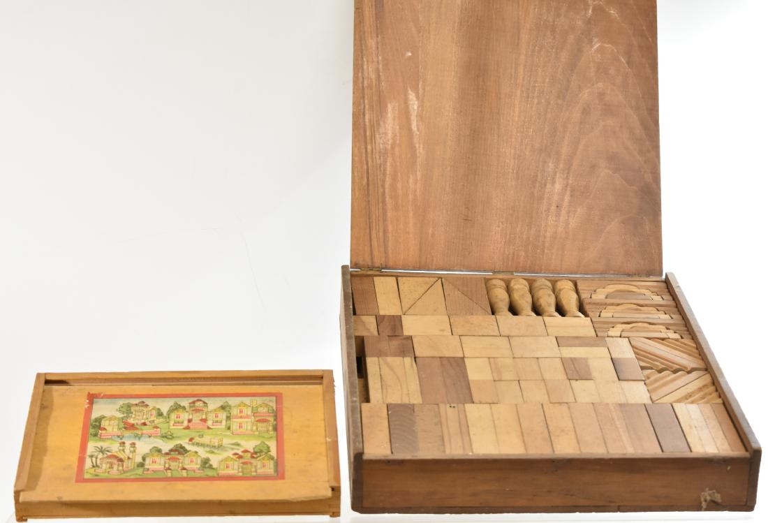 Two Wooden Block Sets: Larger measures approx. 14"h x 12"w. Both sets are for constructing toy buildings. The smaller set has a damaged lid but both sets appear to be complete.