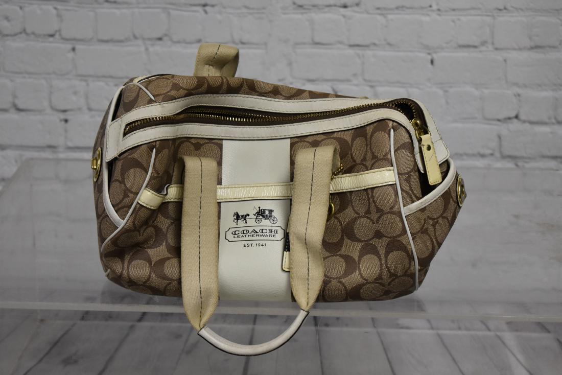 Coach Leatherware Handbag: Item measures approx. 12" across base. It is a leather and canvas bag. The interior has a zipper pouch and the original leather Coach tag.