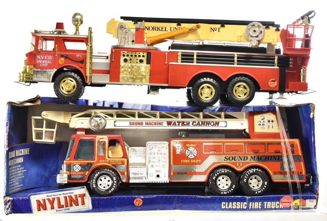 Nylint Large Scale Fire Truck and Another: Lot includes a Nylint Sound Machine measuring approx. 25" in length. Item is unused in box - box shows wear. Lot also includes a New Bright fire engine measuring 28" in length - item has no box.
