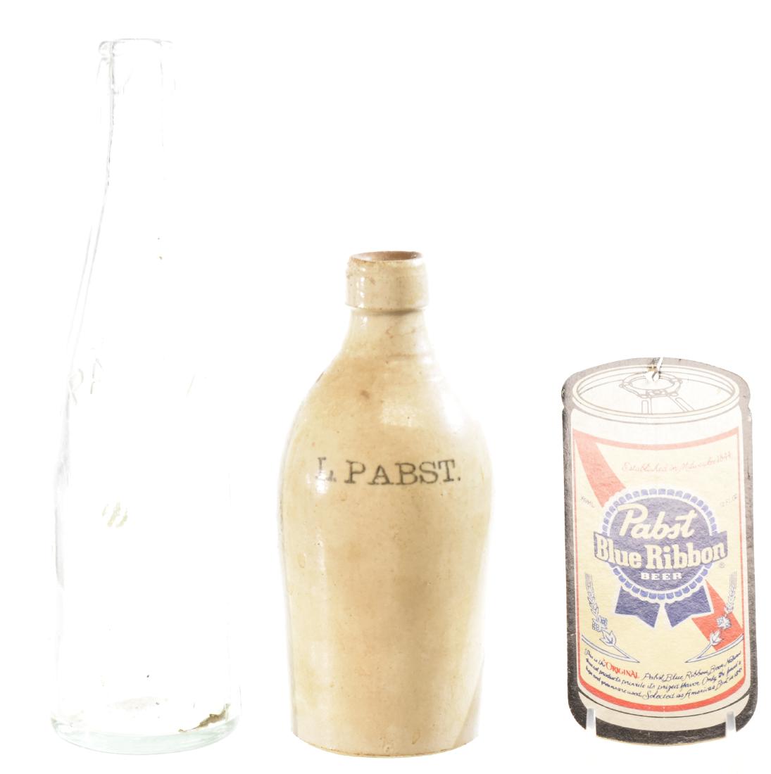 Vintage Pabst Blue Ribbon Items: Including a stoneware Pabst bottle measuring approx. 7"h. a green Pabst bottle with raised lettering and a Pabst Blue Ribbon blind pull.