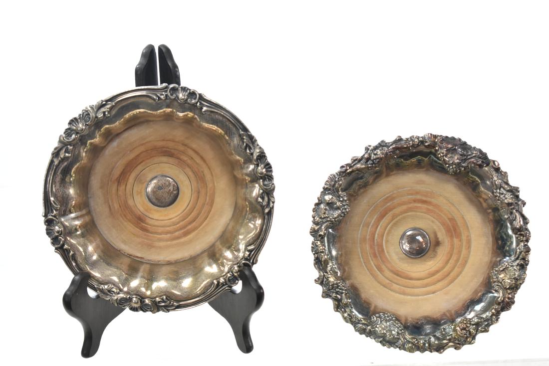 Old Sheffield Plate Wine Caddy and Another: Old Sheffield plate item measures approx. 7"dia and has a wooden center. The other is Victorian silver plate with a grape vine pattern and a wooden center.