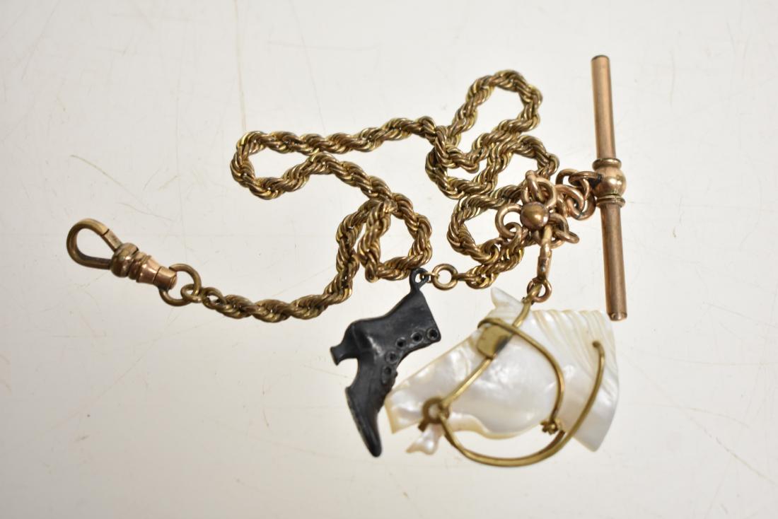 Watch Fob with a Mother of Pearl Horse Head: Brass fob with a mother of pearl horse head and a metal boot.