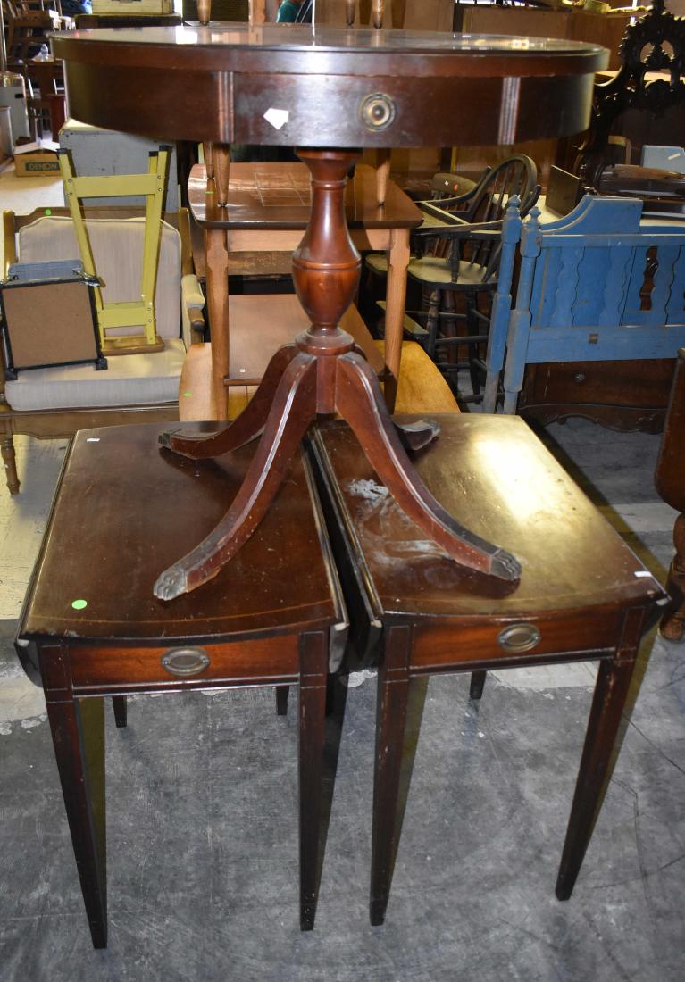 Mahogany Furniture Grouping: Including a drum table measuring approx. 27"h x 28"dia. Lot also includes a pair of mahogany drop leaf side tables with drawers. Note: drum table top needs to be reglued to base.