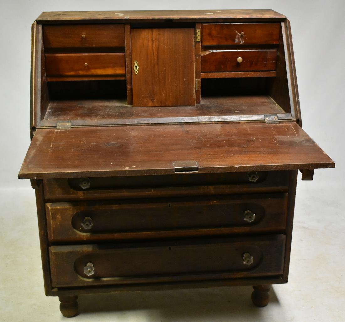 19th Century Drop Front Desk: Desk measures approx. 48"h x 40"w x 19"d. The hinges have been drilled and screwed through the face, the interior is complete and item shows wear.