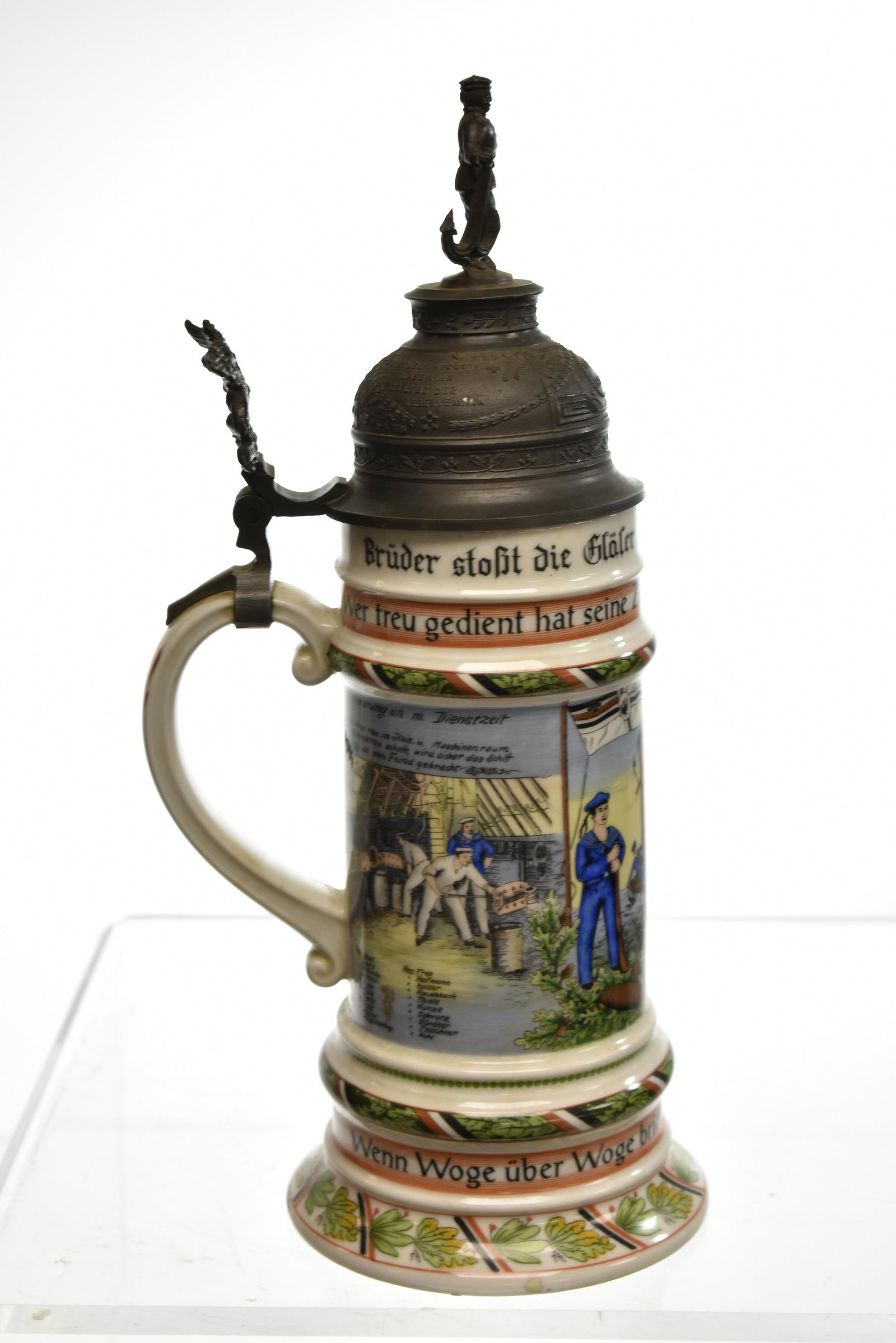 "Kaiser" German Naval Stein with Lithopane: Measures approx. 13"h. It has a sailor finial, a griffon on the handle, nautical graphics and has an interior lithopane of a sailor and a woman. Item is in delicately used condition and is marked "Kai