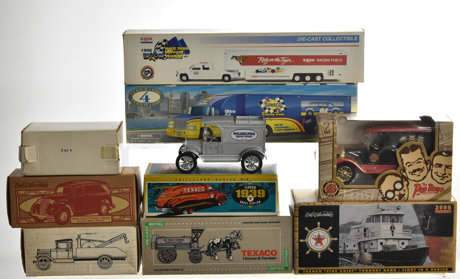 Die cast Car Grouping: Including an Exxon and Sunoco truck in boxes. 3 Texaco vehicles in boxes. Three Ertle and Pep boys.