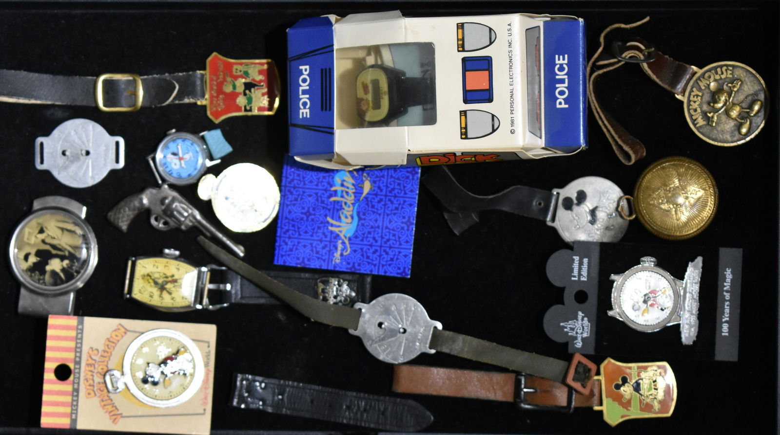 Walt Disney Premiums and Souvenirs: Six Mickey Mouse fobs and pins, Three Stooges metal money clip, Three Little Pigs watch fob, plus Lone Ranger, Dick Tracy, Aladdin and Snoopy fantasy wrist watches (one in original tin), cast toy mini