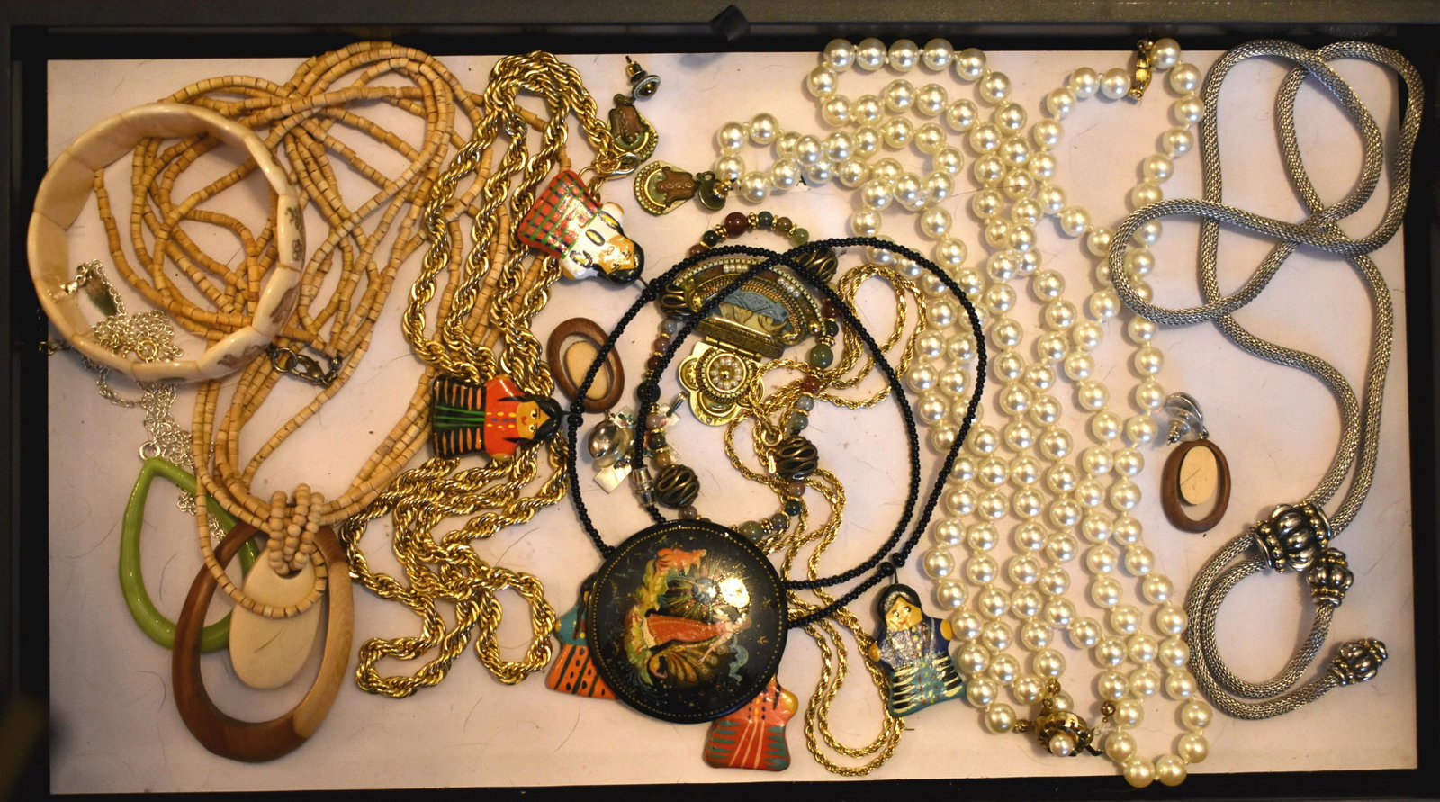 Costume Jewelry: Pins, earrings, 2 faux pearl necklaces, Bolo, silver necklace, and a mother of pearl cross.