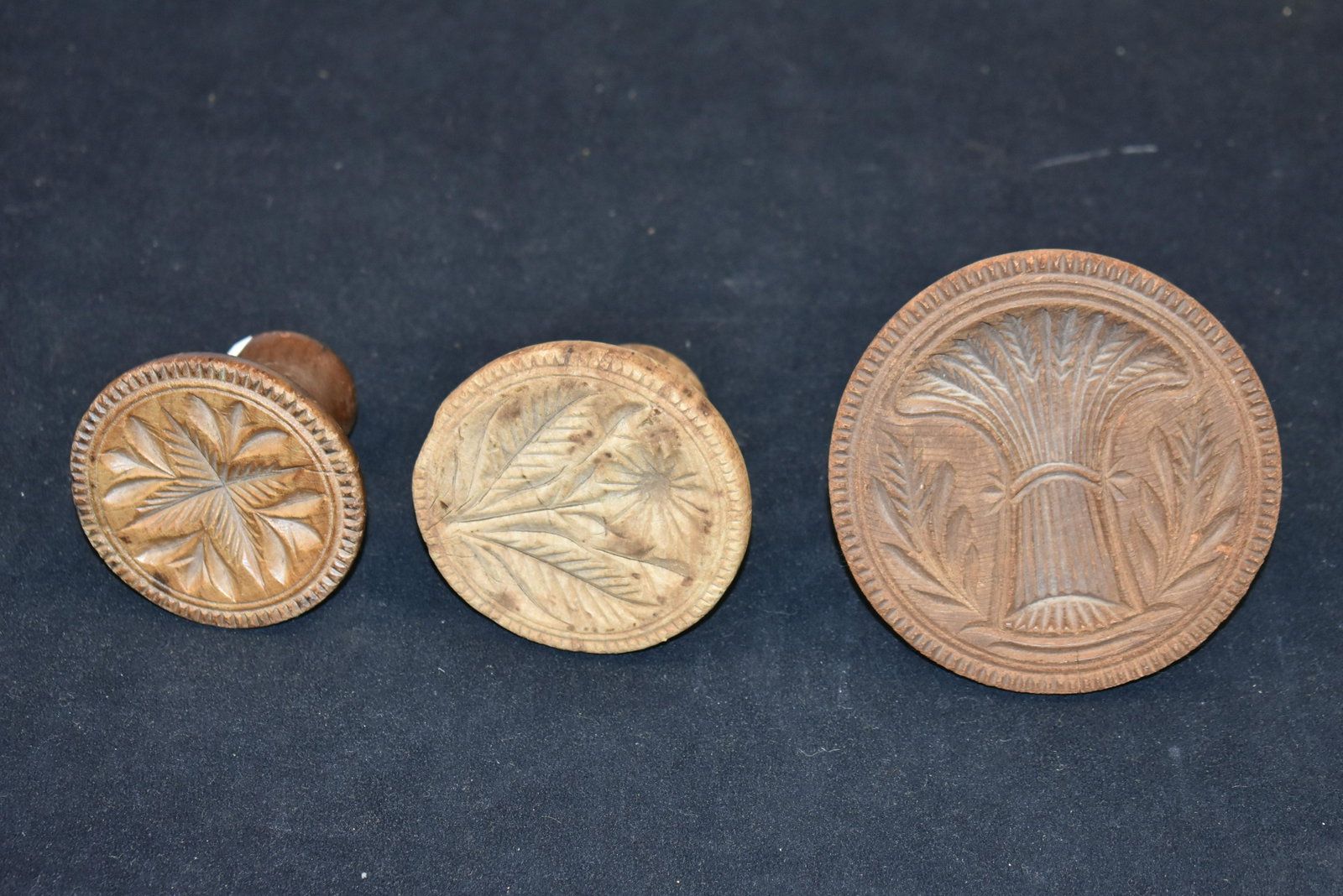Collection of 19th C Butter Prints/Molds: largest is a sheaf of wheat pattern and two floral patterns, largest is 4.5" dia