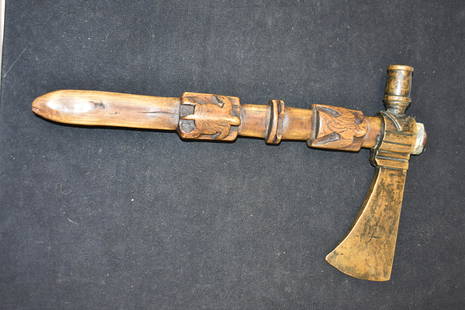 American Indian Tomahawk Peace Pipe: American Indian tomahawk peace pipe with carved hawks and turtles handle. Handle carvings are two sided and also has a hole extending from the bowl in the axe head to the tip of the handle. Attributed