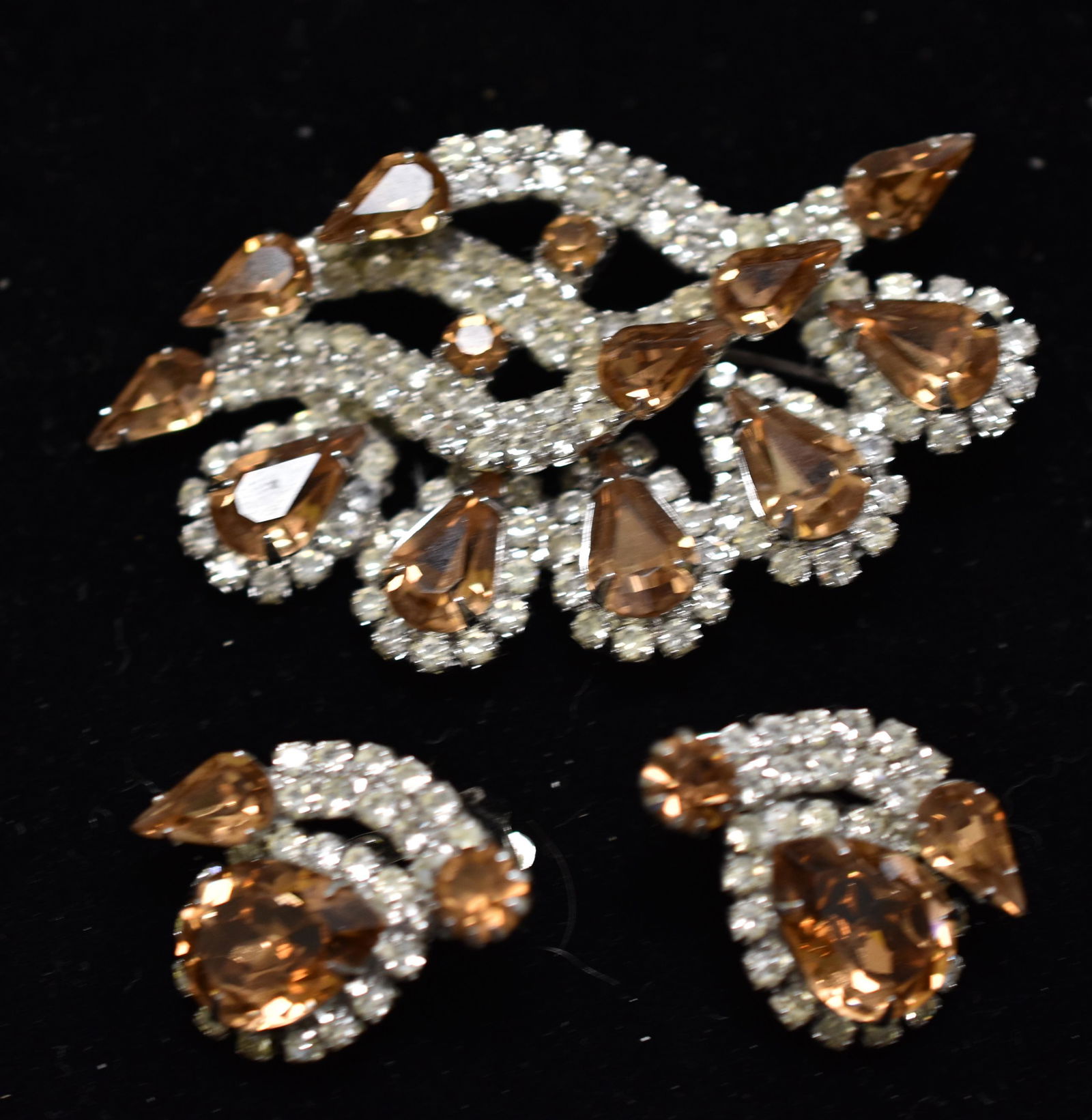 Kramer Rhinestone Jewelry Set: including a brooch and clip earrings with clear and smoky topaz rhinestones.